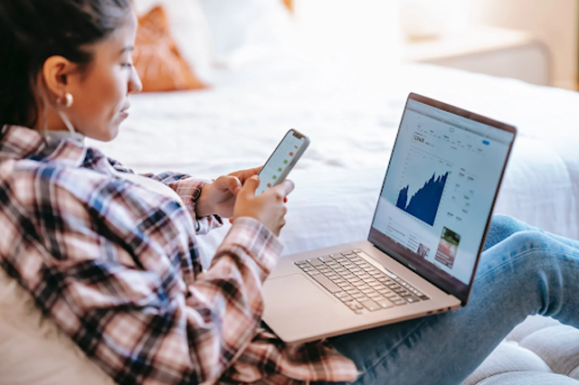 Monitoring your channel growth is very important for knowing your current status and seeing what you need to improve and maintain. “Crop ethnic trader with smartphone and laptop on bench indoors,” by “Liza Summer” licensed under “Pexels.”