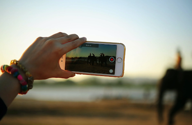 Video making is one of the biggest sources of income on Youtube. Image: Person Taking Photo of Elephants, by Teono123 No, licensed under Pexels.